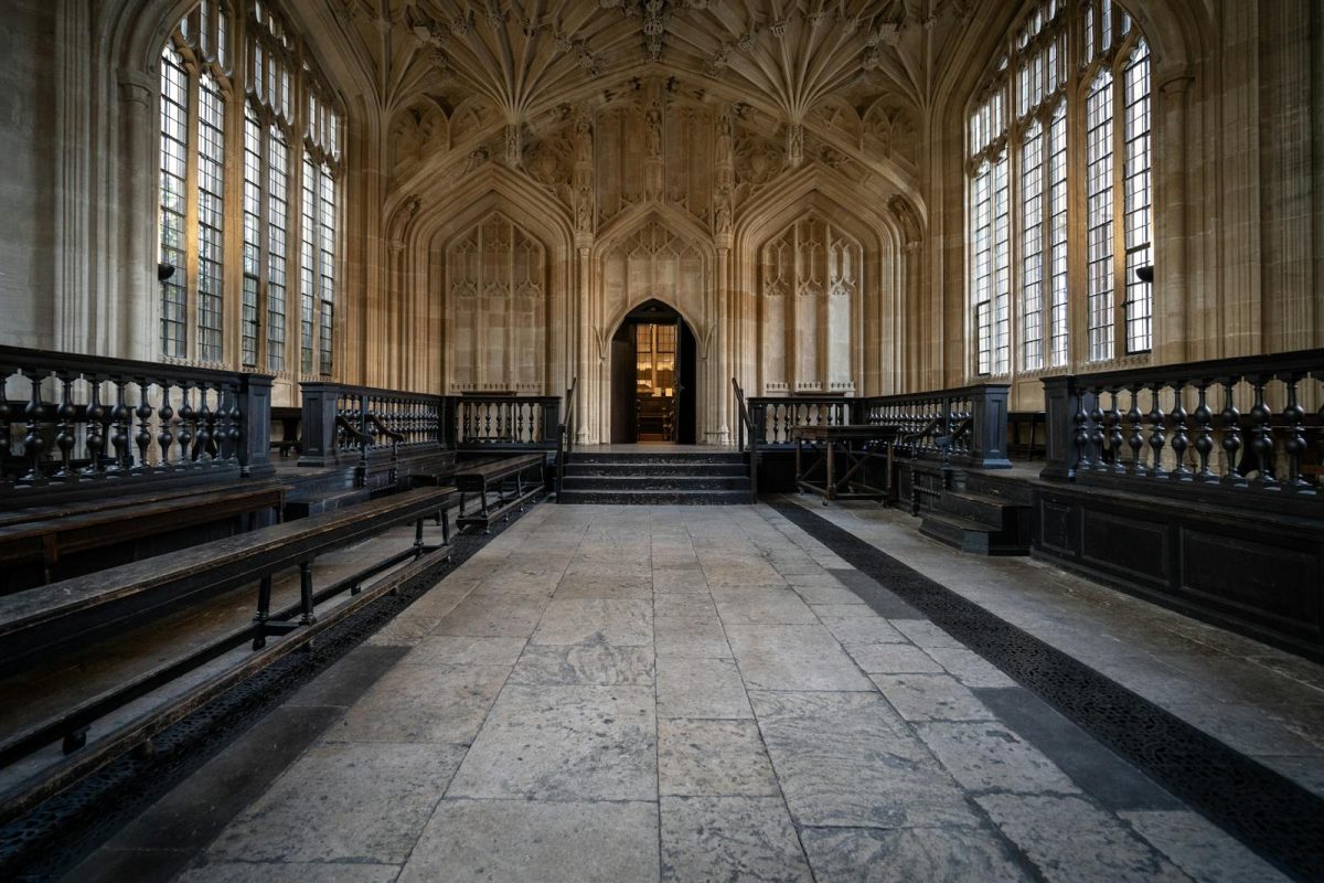 Elegant Gothic interior hallway at Oxford University showcasing symmetrical architecture.