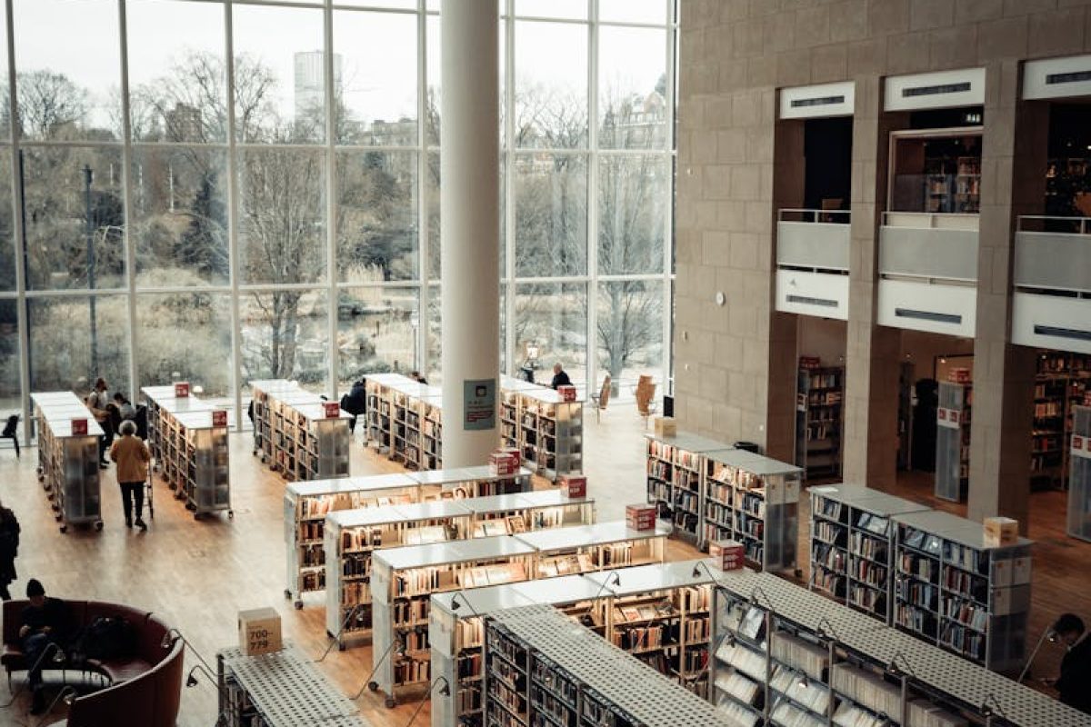 Spacious library interior with large windows and bookshelves in Malmö, Sweden.