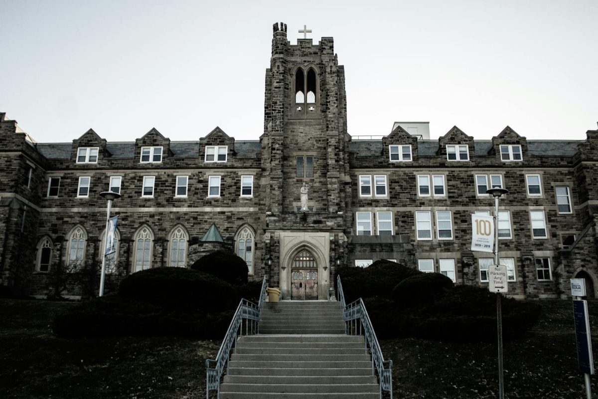 Stone facade of a Gothic-style building with a tower in London, Ontario, Canada.