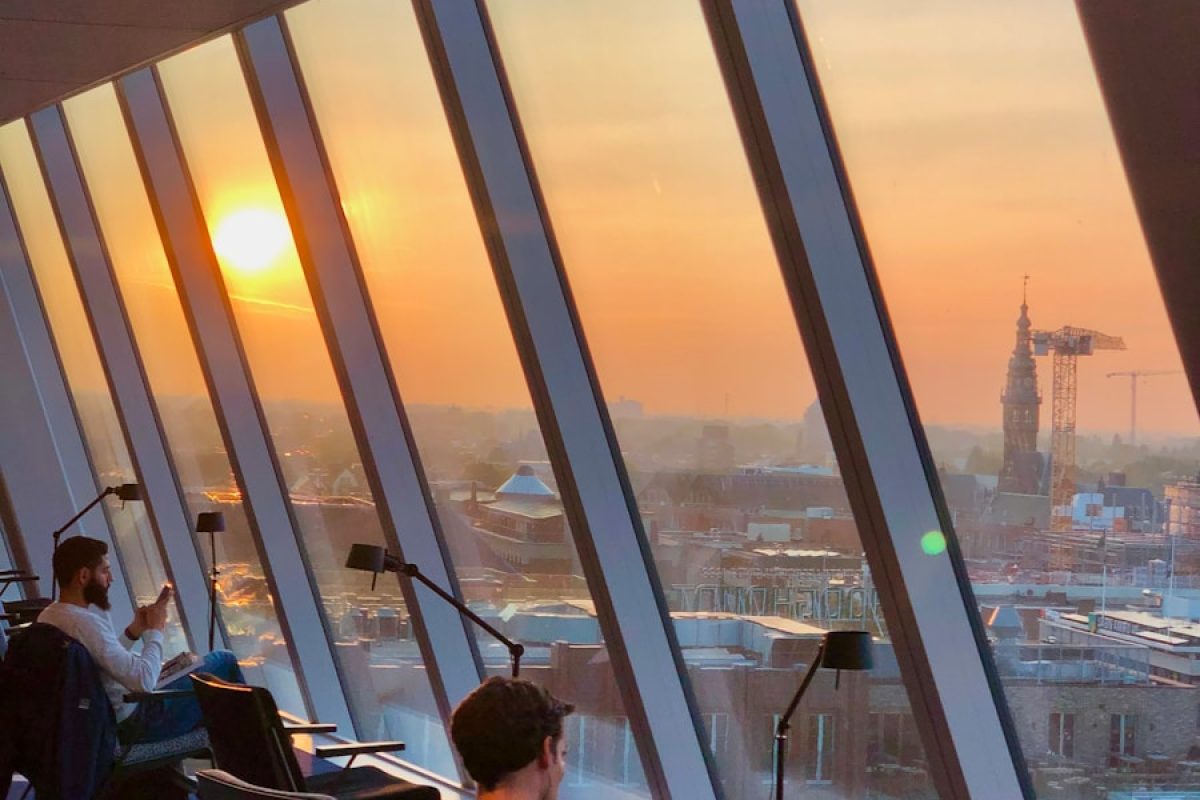 a man sitting in a chair in front of a window