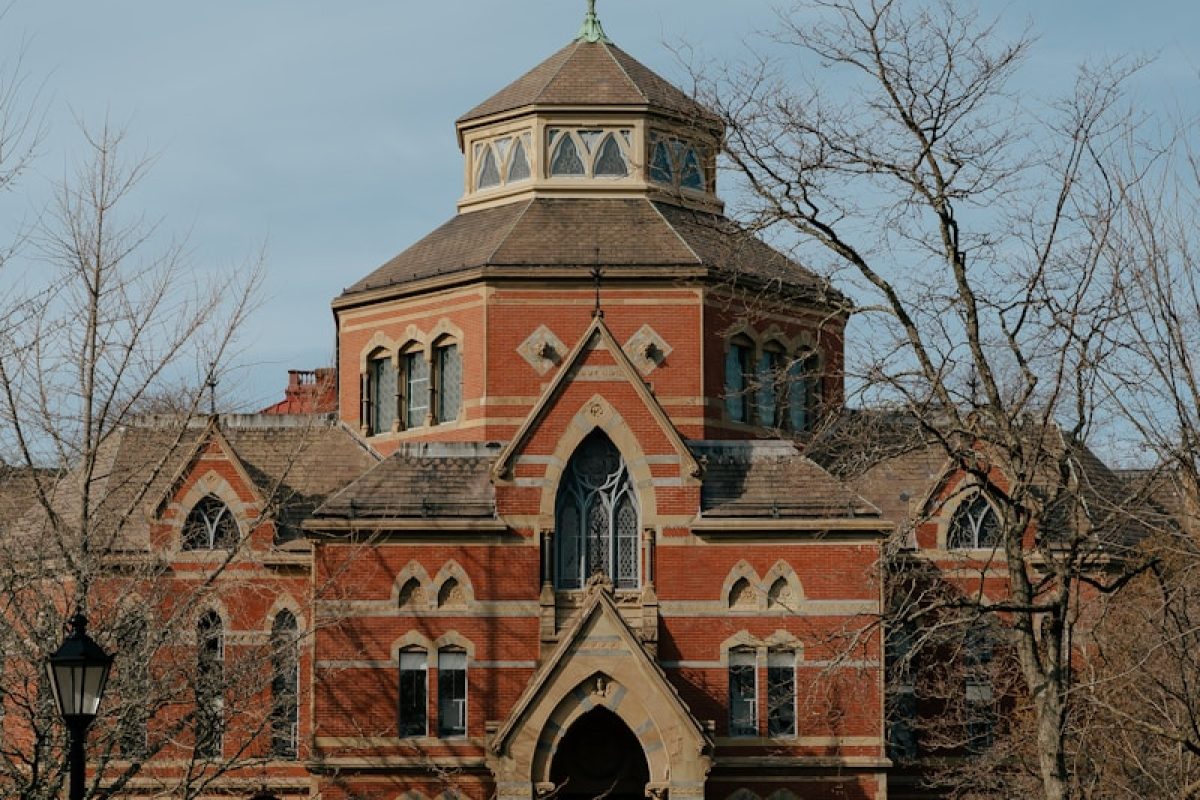 a large red brick building with a clock tower