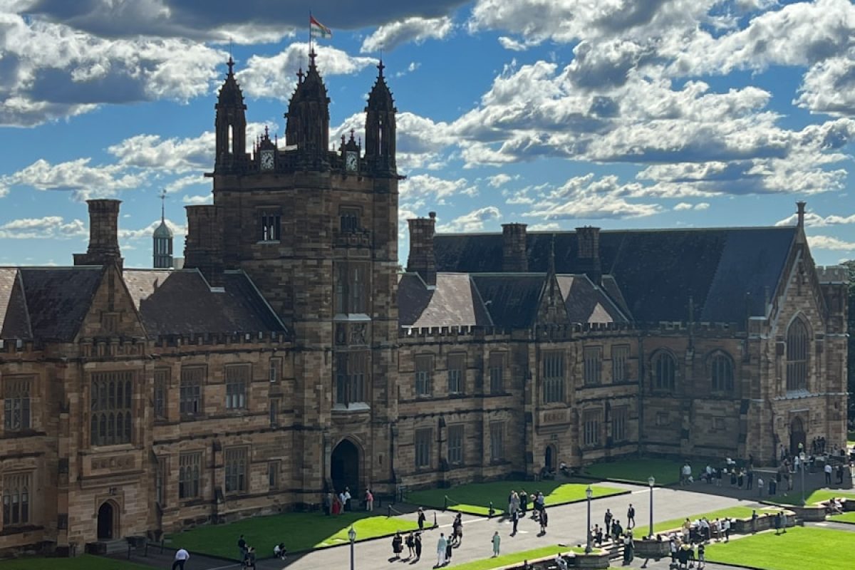 a large building with a lawn in front of it